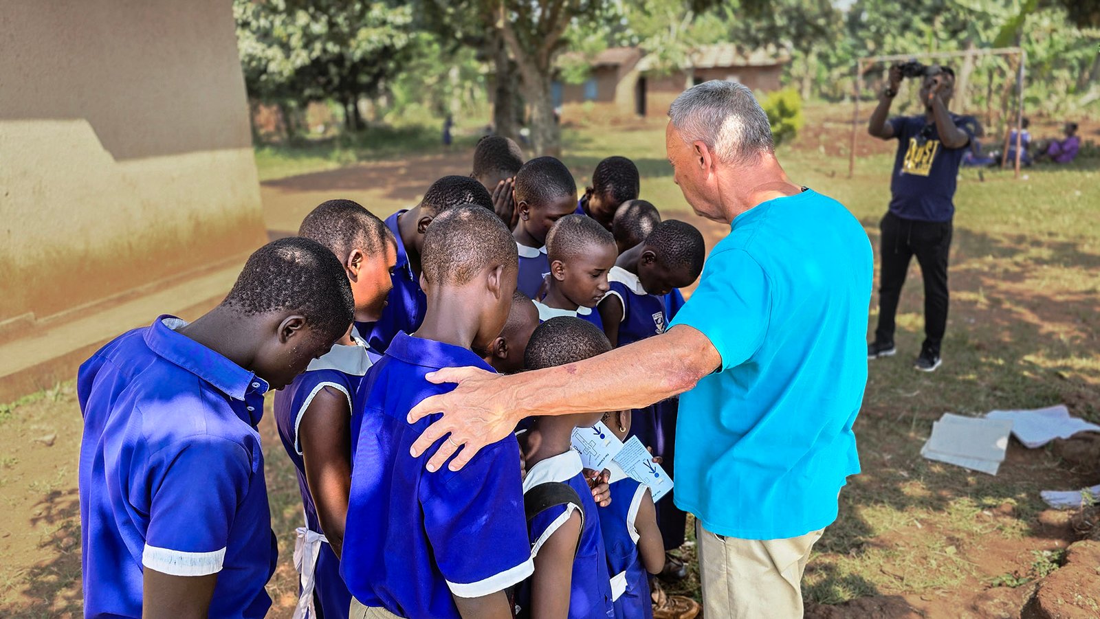 Pastor Alex Praying with Sponsored children